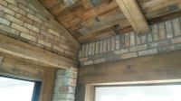 Beautiful wall to ceiling detail mating the beauty of century old barn beams and wood with Chicago brick.