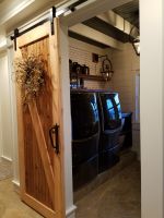 Hand crafted sliding barn door created for this laundry room