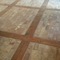 Getting ready for a final cleaning, this office entryway floor was created using Chicago Common bricks and reclaimed lumber.