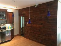 Also added was the covering of this accent wall, with the same rich warm pieces of reclaimed lumber