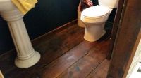 Century old tongue and groove flooring from an Elkhorn, Wisconsin barn was used on this Chain of Lakes powder room floor
