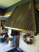 To add another texture element, aside from all the other wood elements in this Chain of Lakes waterfront kitchen, we created a unique exhaust hood using reclaimed vintage tin and hribar.